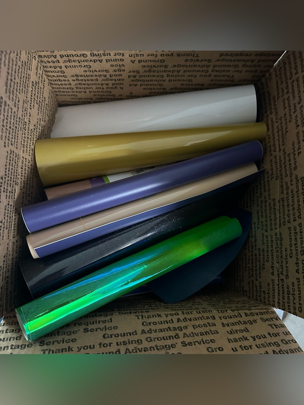 Box of assorted Cricut HTV, removable and permanent vinyl